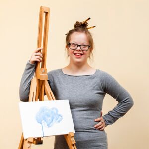 Young lady with down-syndrome painting a picture